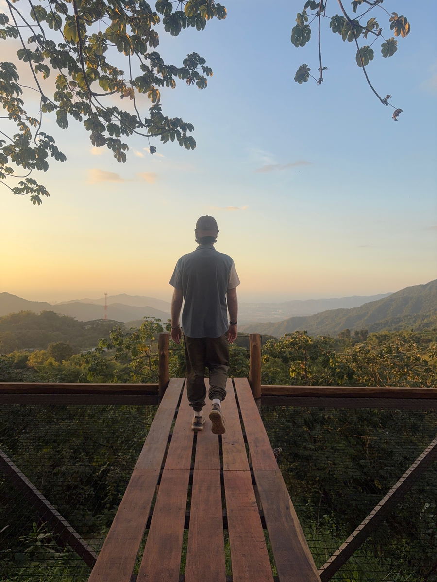 Sam Cornell looking out over a valley at sunrise